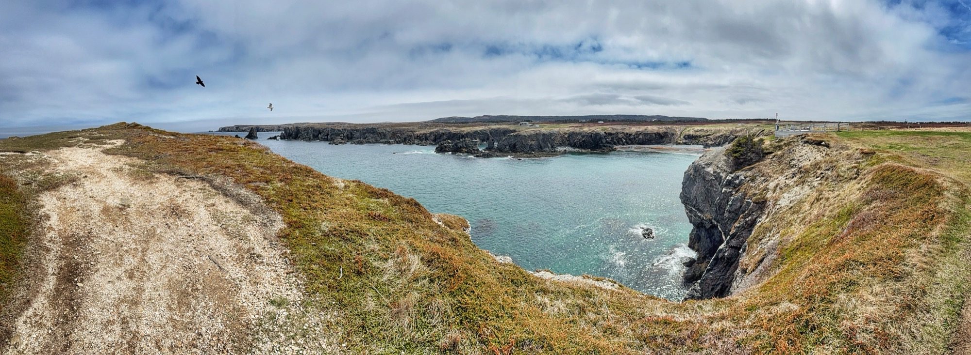 A wide panorama of the rocky coastline and bay near Dungeon Provincial Park