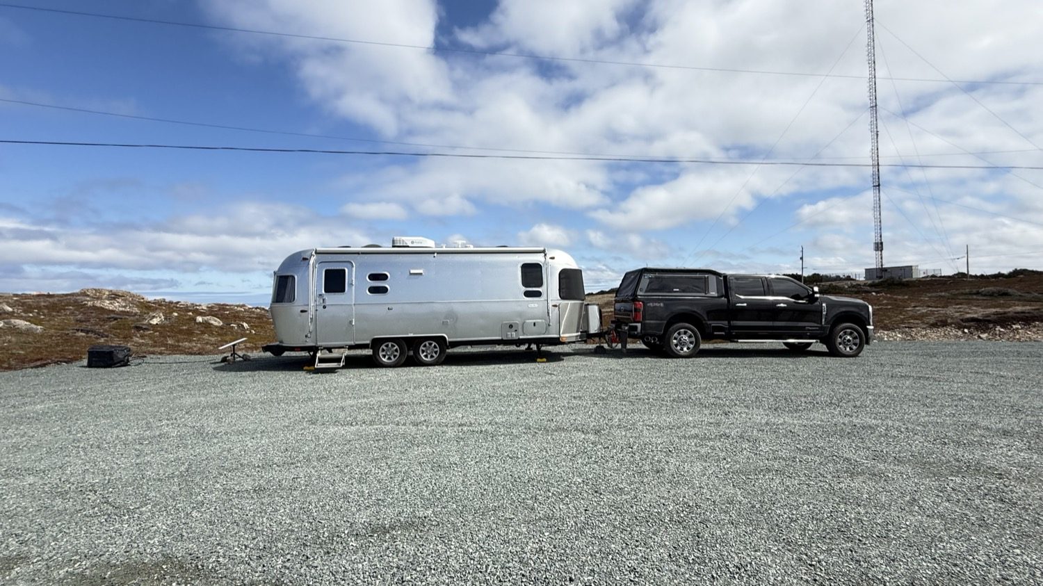 Our truck and Airstream hitched up together in the empty gravel lot at Landfall Municipal Park