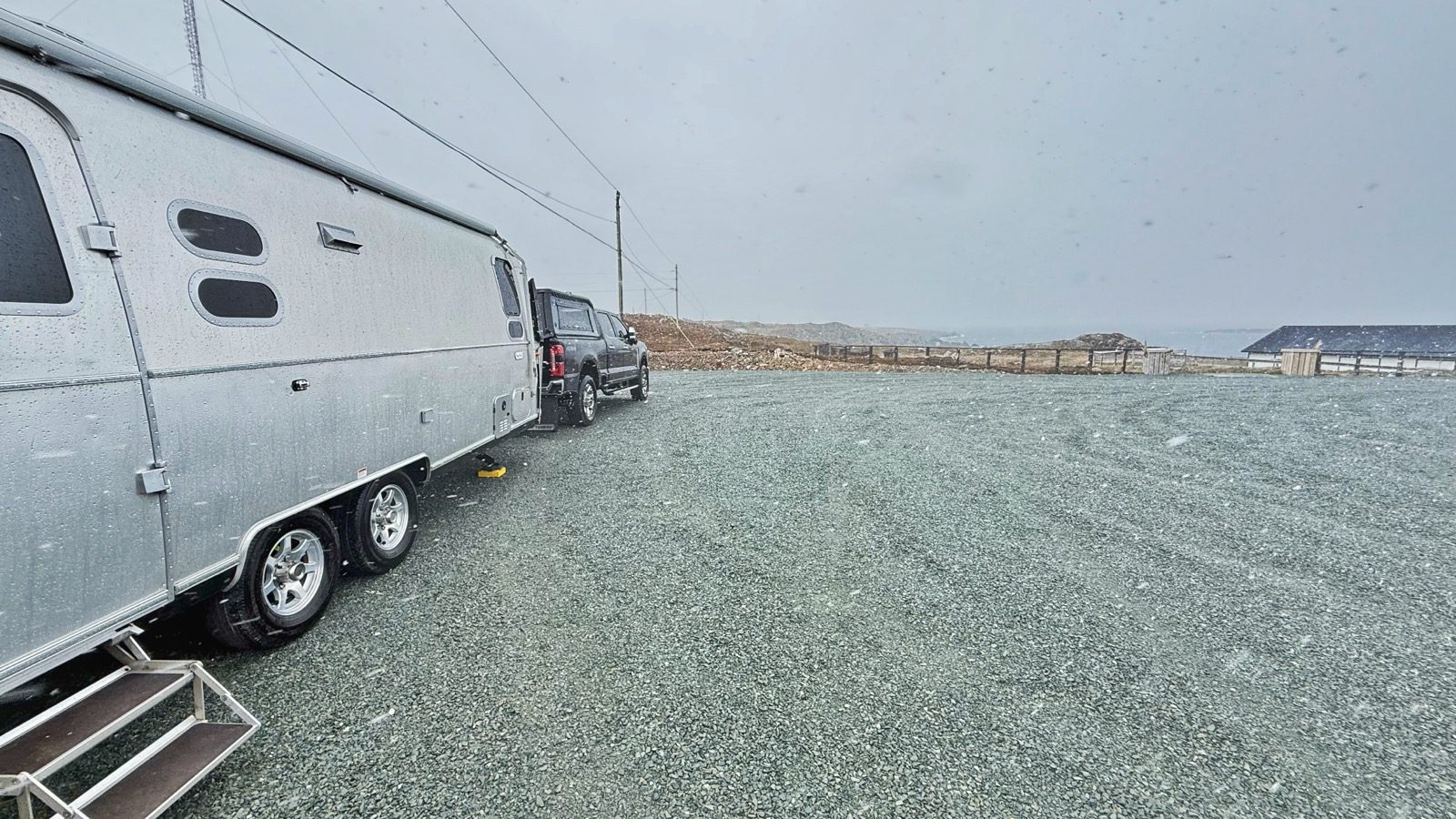 Our Airstream hitched up in a gravel lot near Bonavista during heavy snow and wind