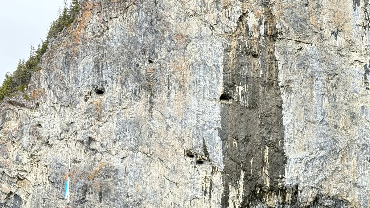 Close-up of the same rock face at left, showing holes left by British Navy cannonballs used for artillery practice