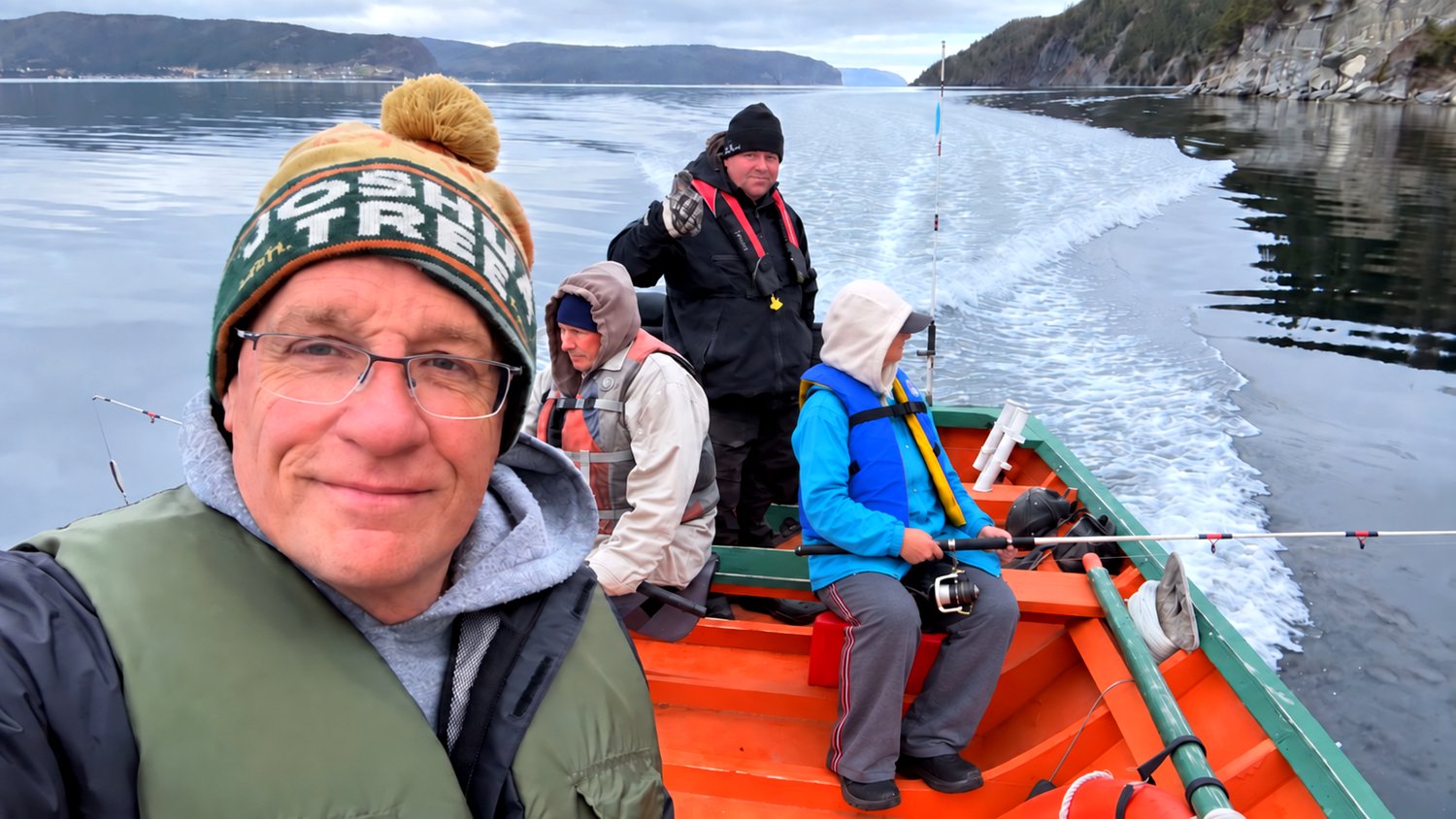 Dan, Heather, Heather's dad, and their guide Darren, out on the boat together in Cox Cove