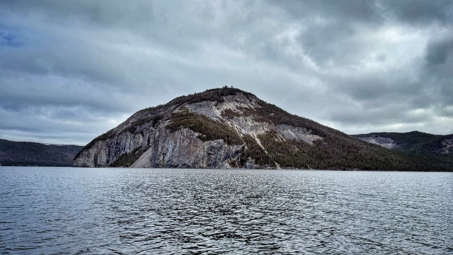 A rocky peak breaking through the tree line above the cove