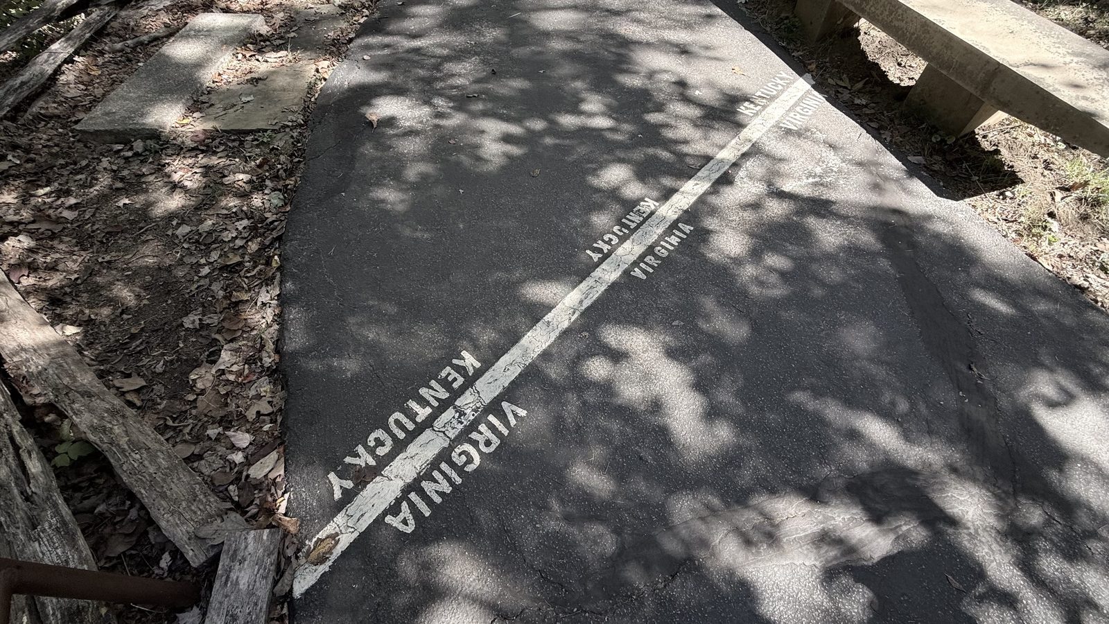 Paint on the pavement marks the state line, with the word Kentucky on one side and Virginia on the other
