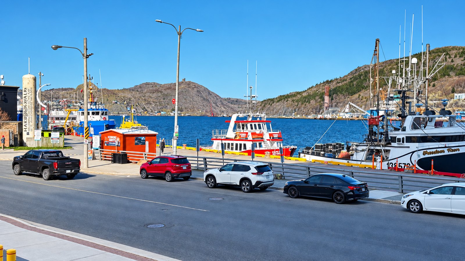 Boats tied up at the St. John's wharf across the street from our table, with Signal Hill and its tower across the water
