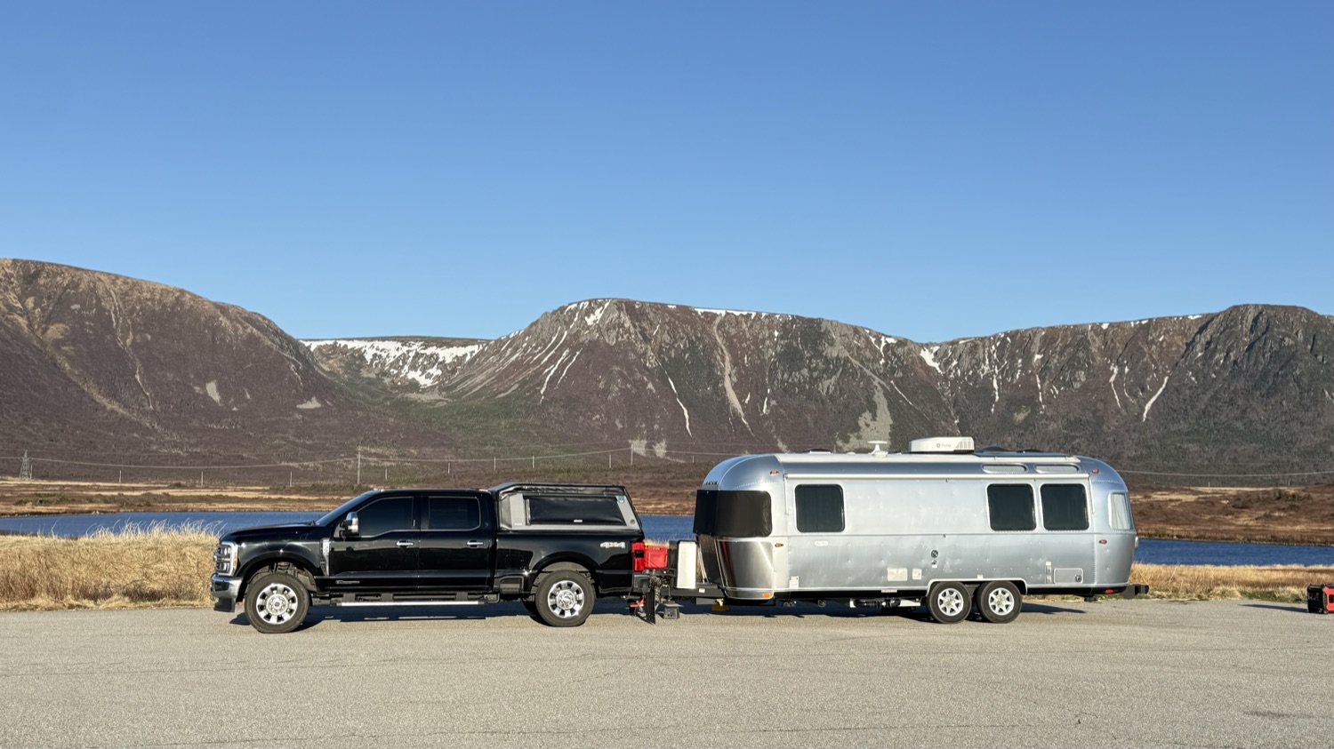 Our truck and Airstream parked near Wreckhouse, with the Long Range foothills rising behind them