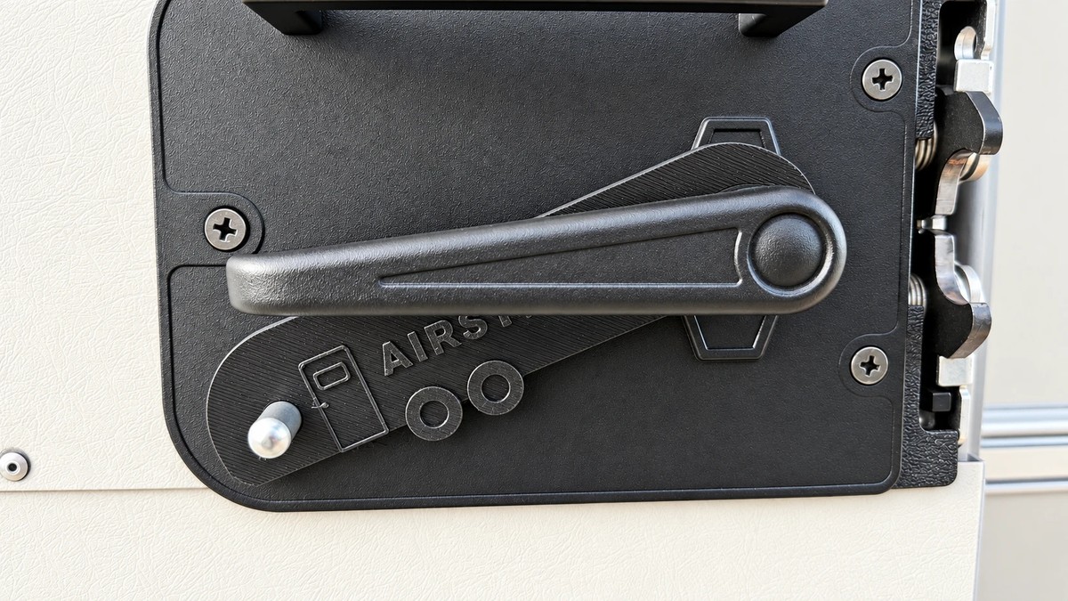 The Gear Pin installed on an Airstream door in the Right orientation, hooked over the lock lever and holding it away from the locked position